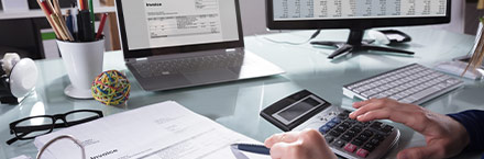 Businessperson Calculating Invoice
