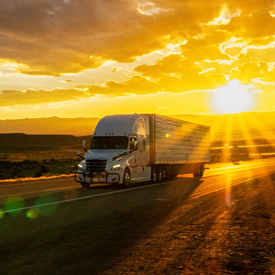 truck driving with sunset